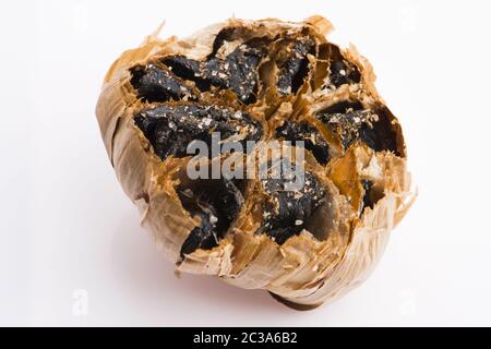 Black garlic cloves isolated on white background Stock Photo