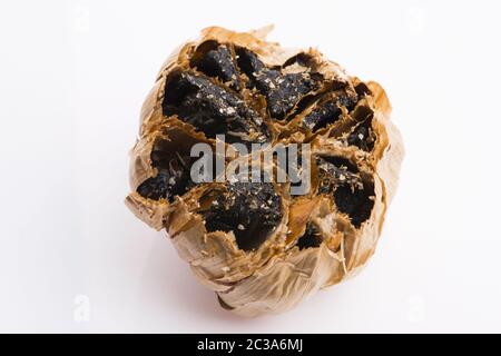 Black garlic cloves isolated on white background Stock Photo