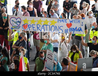 19 June 2020, Hessen, Frankfurt/Main: Lufthansa employees hold up a poster during a protest action by air traffic employees in Terminal 1 of Frankfurt Airport. The Verdi union has called for a nationwide demonstration to draw attention to the situation of ground handling employees. Photo: Arne Dedert/dpa Stock Photo