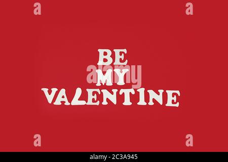 be my valentine phrase made of wooden letters on red background top view copyspace layout Stock Photo