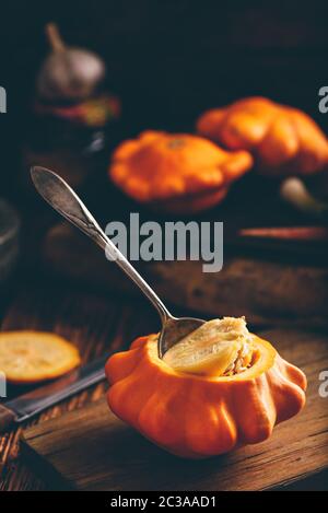 Preparing yellow pattypan squash for stuffing with minced meat Stock Photo