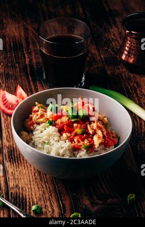 Scrambled eggs with tomatoes, leek and white rice. Turkish coffee and sliced ingredients. Stock Photo