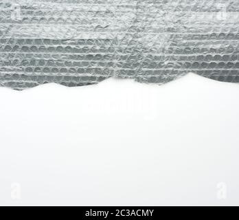 fragment of a transparent film with air for transportation of parcels is glued on gray polyethylene, inside of the envelope Stock Photo