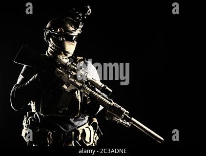 Army elite troops marksman, special operations forces sniper wearing mask and glasses, night-vision or infrared thermal imaging device on helmet, hold Stock Photo