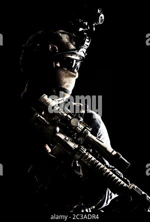 Shoulder portrait of army elite troops sniper, anti-terrorist tactical team marksman wearing helmet with thermal imager, hiding face behind mask, arme Stock Photo