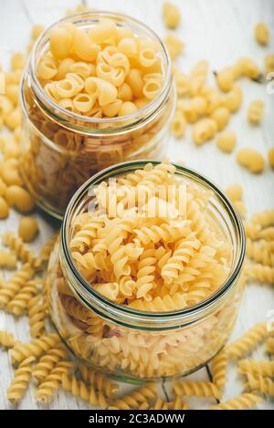 Two kinds of Italian whole wheat pasta in glass jars Stock Photo