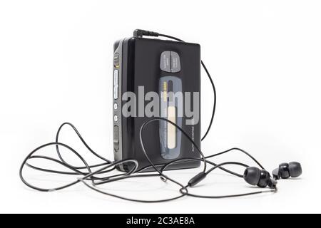 Vintage audio player. Old fashioned portable cassette player, cult object, icon and symbol of the 80s and 90s. Headphones isolated on white background Stock Photo
