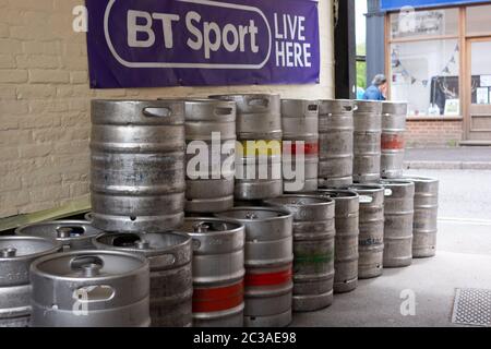 Beer kegs stacked up in a courtyard outside a pub in England Stock Photo