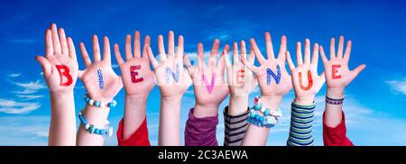 Children Hands Building Colorful French Word Bienvenue Means Welcome. Blue Sky As Background Stock Photo