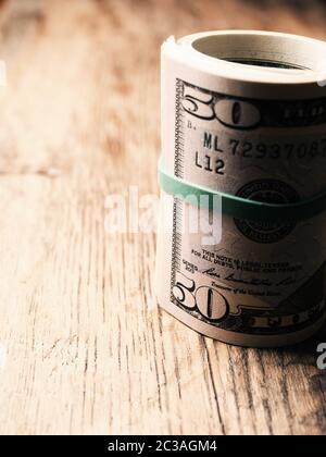 Dollar banknotes on a wooden table, abundance or wealth concept Stock Photo