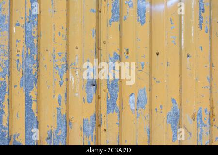 Detail shot of an old yellow corrugated metal door texture, suitable for cg artworks Stock Photo
