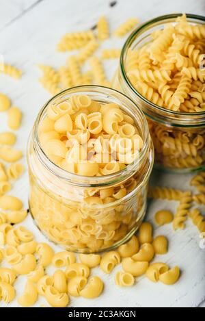 Two kinds of Italian whole wheat pasta in glass jars Stock Photo