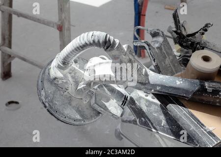 Close up of Sanding machine and painter or plasterer tools on construction site. Stock Photo