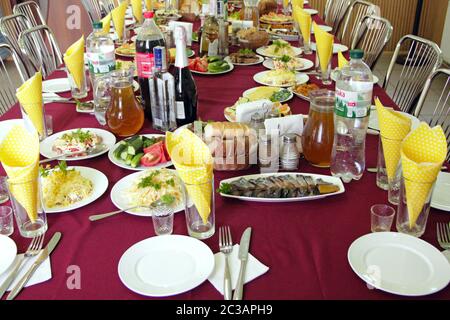 Festive table with delicious dishes. Many food on table for family holiday. Banquet table with delic Stock Photo