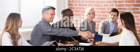 Businesspeople Shaking Hands After Interview In Office Stock Photo