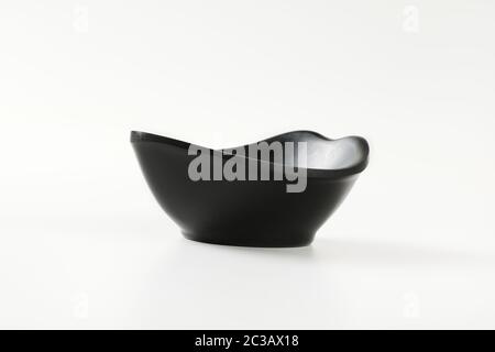 Curve black bowl for serving snacks and nuts Stock Photo