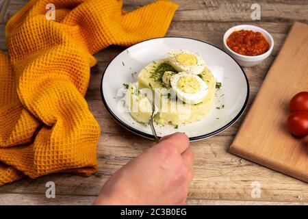 Potato food . Ingredients for mashed potatoes - eggs, milk, butter and potatoes on wooden background. Top view Stock Photo