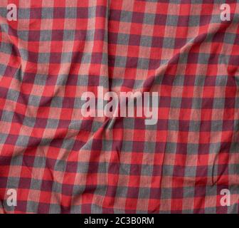 red checkered fabric for sewing various clothes with waves, full frame Stock Photo