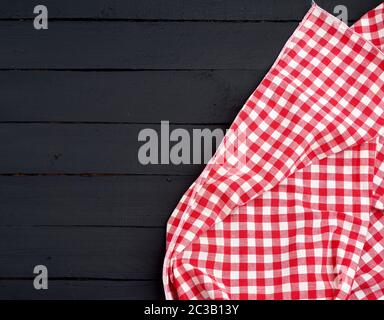 white red checkered kitchen towel on a dark blue wooden background, picnic background, copy space Stock Photo