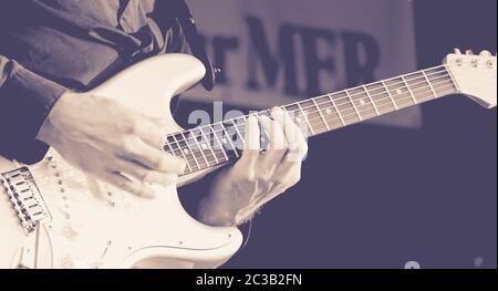 Close up of hands of a man playing a electric guitar. black and white image Stock Photo