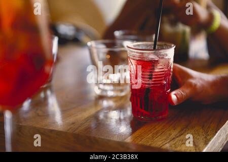 Crop person enjoying cold drink in cafe Stock Photo