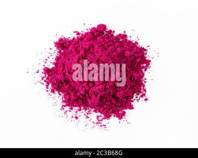 Dragon fruit powder heap isolated on white with clipping path. Perfect bright magenta freeze dried pitahaya cactus or Hylocereus costaricensis powder. Stock Photo