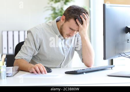 Sad entrepreneur complaining looking at negative chart at office Stock Photo
