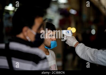 Mexico City, Mexico. 18th June, 2020. A customer has his temperature checked at a wholesale food market amid the COVID-19 outbreak in Mexico City, Mexico, on June 18, 2020. Credit: Francisco Canedo/Xinhua/Alamy Live News Stock Photo