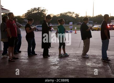 November 6th, 2012 Austin, Texas: Voters stand in line and review ballot waiting to cast their vote in Travis County Texas.   ©MKC / Daemmrich Photos Stock Photo