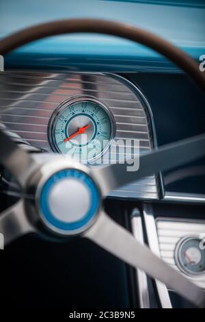 Color close up shot of a tachometer on a vintage car's dashboard. Stock Photo