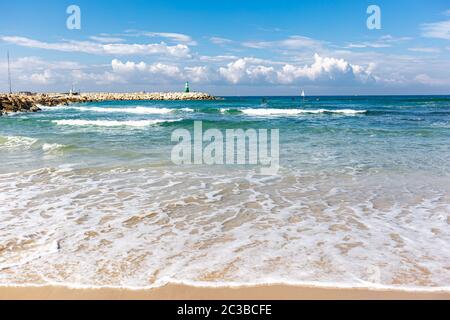 Amazing Mediterranean beach with lighthouse and sailboats  in Tel Aviv Israel. Stock Photo