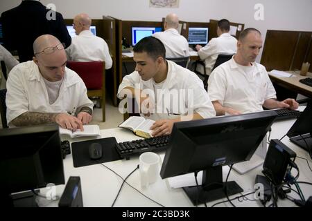 Rosharon Texas USA, August 25 2014: Male prison inmates, students who are enrolled in the Southwestern Baptist Theological Seminary program at Darrington prison, use computers in their classroom, where they are allowed to interact with each other.   ©Marjorie Kamys Cotera/Daemmrich Photography Stock Photo