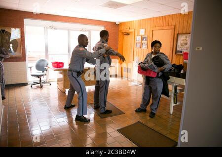 Rosharon Texas USA, August 25 2014:  To help reduce the amount of contraband found, prison guards go through a metal detector and are hand searched by another guard as part of the extensive security check they receive each time they arrive for their work shift   Marjorie Kamys Cotera/Daemmrich Photography Stock Photo