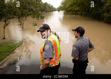 Austin Texas USA, October 30 2015: County animal services workers look out for animals needing help along Onion Creek, which flooded through several neighborhoods earlier in the day after 11 inches of rain fell in its watershed after midnight.  ©Marjorie Kamys Cotera/Daemmrich Photography Stock Photo