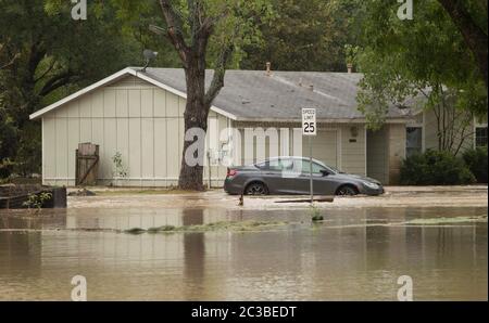 Austin, Texas USA, October 30 2015: Partially submerged car and street sign in the Onion Creek neighborhood in south Austin after the area received more than 11 inches of rain earlier in the day.  ©Marjorie Kamys Cotera/Daemmrich Photography Stock Photo