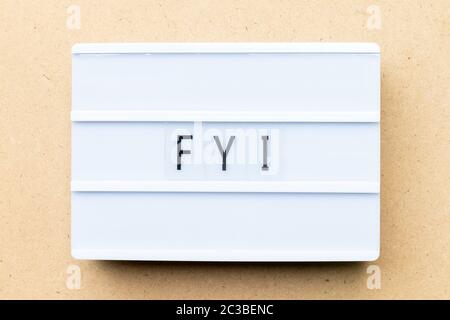White lightbox with word FYI (Abbreviation of For your information) on wood background Stock Photo