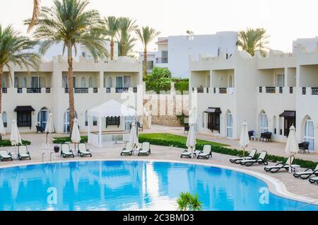 White houses and swimming pool on territory of five star hotel in Sharm El Sheikh. Summer in Egypt. Stock Photo