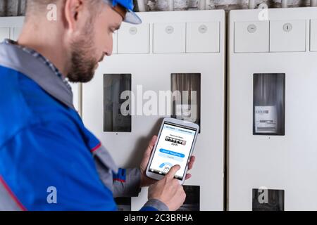 Male Technician Doing Meter Reading Using Tablet Stock Photo