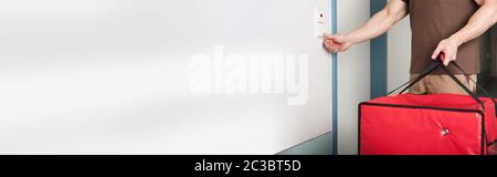 Close-up Of A Young Pizza Delivery Man Ringing The Door Bell Stock Photo