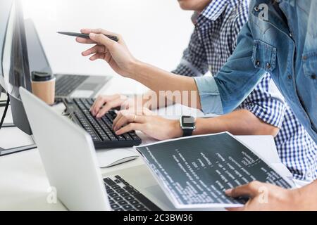 Asian team Outsource Developer Looking Screen Programming Code Working with Laptop Computer Software Stock Photo