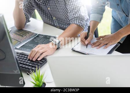 Asian team Outsource Developer Looking Screen Programming Code Working with Laptop Computer Software Stock Photo