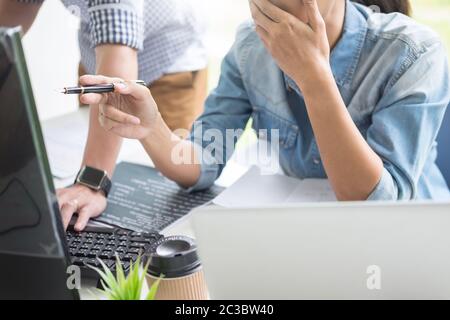 Asian team Outsource Developer Looking Screen Programming Code Working with Laptop Computer Software Stock Photo
