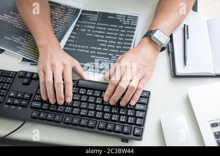Asian team Outsource Developer Looking Screen Programming Code Working with Laptop Computer Software Stock Photo