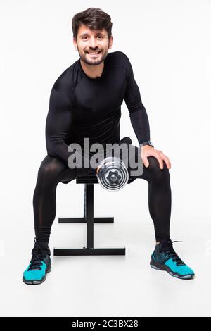 Attractive powerful muscular man lifting dumbbell in sport gym isolated on white background. Body builder concept Stock Photo
