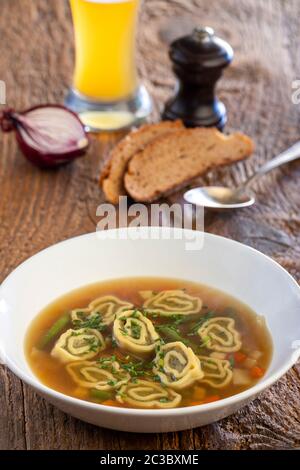 bavarian maultasche soup on wood Stock Photo