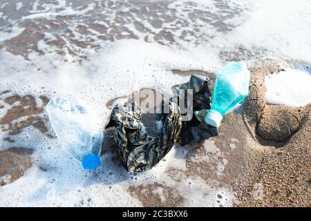 Used Plastic On Shore. Environmental Pollution Concept Stock Photo