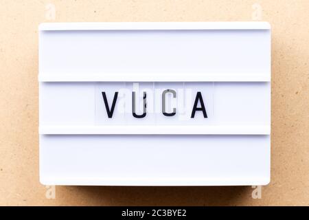 Lightbox with word VUCA (abbreviation of Volatility, uncertainty, complexity and ambiguity) on wood background Stock Photo