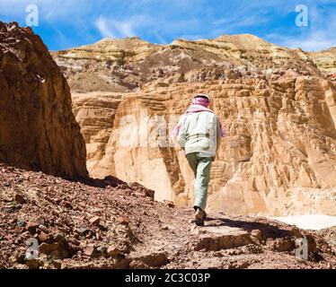 Bedouin climbs a mountain in a canyon in Egypt Dahab South Sinai Stock Photo