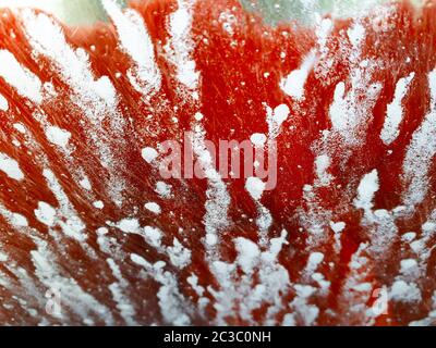 Artistic abstract patterns made on a windscreen whilst car is in a car wash Stock Photo