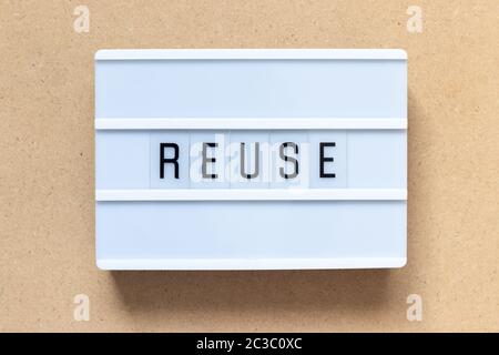 White lightbox with word reuse on wood background Stock Photo